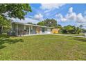 Charming single-story home with a well-manicured lawn, a covered front porch, and an attached garage at 1260 S Hillcrest Ave, Clearwater, FL 33756