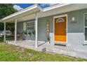 Inviting front porch featuring stylish tile flooring, seating, and a welcoming entryway to the home at 1260 S Hillcrest Ave, Clearwater, FL 33756