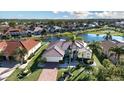 An aerial view of a community with homes surrounding a small lake at 1308 Crystal Greens Dr, Sun City Center, FL 33573