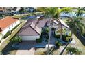 An aerial view of a well maintained home with mature landscaping and brick paver driveway at 1308 Crystal Greens Dr, Sun City Center, FL 33573