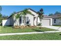 Charming single-story home featuring fresh landscaping, a well-manicured lawn, and a neutral-toned exterior at 13355 Willow Bluestar Loop, Riverview, FL 33579