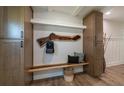 Stylish entryway featuring custom cabinets, bench with pillows, and a unique wood accent coat rack at 1510 49Th N St, St Petersburg, FL 33710