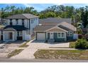 Beautiful craftsman-style home features a brick driveway, attached garage, front garden, and two-story addition at 1510 49Th N St, St Petersburg, FL 33710