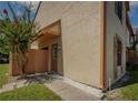The home features a private entrance, small patio, and beautiful landscaping at 1701 Brigadoon Dr, Clearwater, FL 33759