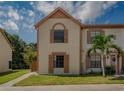 Charming townhouse with two stories, neutral paint, and decorative shutters at 1701 Brigadoon Dr, Clearwater, FL 33759