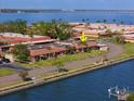 Scenic aerial view of waterfront community with a canal, tile roofs and beautiful landscaping at 19029 Us Highway 19 N # 21E, Clearwater, FL 33764