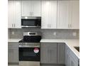 Modern kitchen features stainless steel appliances, quartz countertops and stylish backsplash at 19029 Us Highway 19 N # 21E, Clearwater, FL 33764