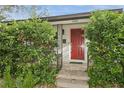 Inviting home entrance with red door, lush greenery, and stylish details at 2465 9Th N Ave, St Petersburg, FL 33713