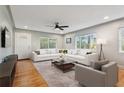 Bright living room with hardwood floors, large windows, and white sofa and chair set, ideal for relaxing or entertaining at 2465 9Th N Ave, St Petersburg, FL 33713
