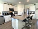 Beautiful kitchen boasting stainless steel appliances, modern cabinetry, and a spacious island at 31888 Treasure Dock Isle, Wesley Chapel, FL 33545