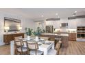 Bright dining area open to the kitchen, featuring stylish decor, seating, and ample natural light at 34088 Anchor Light Ln, Wesley Chapel, FL 33543