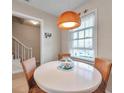 Bright breakfast nook with white table and chairs with coastal decor and natural light at 4766 Snook Se Dr, St Petersburg, FL 33705