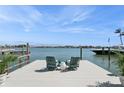 Scenic view from the private dock, featuring comfortable seating and stunning waterfront scenery under a bright sky at 540 59Th Ave, St Pete Beach, FL 33706