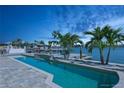 Luxury waterfront home showcases a private pool and dock with easy access to the bay and stunning twilight views at 540 59Th Ave, St Pete Beach, FL 33706