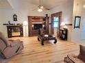Inviting living room with hardwood floors, ceiling fan, and a decorative entertainment center at 7016 2Nd N St, St Petersburg, FL 33702