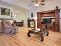 Spacious living room with light hardwood floors and a decorative entertainment center adjacent to dining area at 7016 2Nd N St, St Petersburg, FL 33702