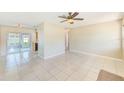 Spacious living room with tile flooring, leading to a sunroom with sliding glass doors at 7041 Daggett Ter, New Port Richey, FL 34655