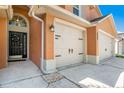 Home exterior showcases a three-car garage and a welcoming front door with decorative wreath at 7116 Colonial Lake Dr, Riverview, FL 33578