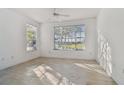 Bright, airy bedroom featuring modern flooring and an abundance of natural light at 9008 Lake Chase Island Way, Tampa, FL 33626