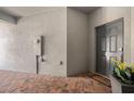 Inviting entryway featuring brick flooring, a modern front door, and a welcoming doormat at 10106 Corso Milano Dr, Tampa, FL 33625