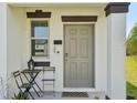 Inviting front door with a small table and chairs creating a cozy entrance at 11944 Miracle Mile Dr, Riverview, FL 33578