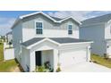Attractive two-story home with a two-car garage, manicured lawn, and neutral color scheme at 12294 Cypress Branch St, Riverview, FL 33579