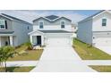 Inviting two-story home featuring a two-car garage, landscaped front yard, and a welcoming entrance at 12294 Cypress Branch St, Riverview, FL 33579