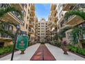 Beautiful courtyard leading to the Flori-de-Leon Apartments, a historic building with mature landscaping at 130 4Th N Ave # 315, St Petersburg, FL 33701