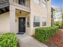 Condo's front door features a black door, house number and a concrete walkway at 2400 Feather Sound Dr # 1118, Clearwater, FL 33762