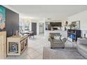 Open-concept living area with tile flooring, modern lighting, and combined living and dining spaces at 2400 Feather Sound Dr # 1118, Clearwater, FL 33762