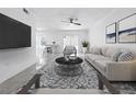 Beautifully staged living room with sleek furnishings, stylish rug, and flat screen television at 2523 Northfield Ln, Clearwater, FL 33761