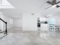 Spacious living area features updated tile floors, modern finishes, and an open floor plan at 2523 Northfield Ln, Clearwater, FL 33761