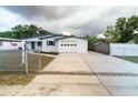 Charming single-story home boasts a freshly painted exterior, an attached garage, and a well-maintained front yard at 2610 E Yukon St, Tampa, FL 33604