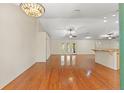 Open-concept living room featuring hardwood floors, high ceilings, and ample natural light at 26290 Hayman Rd, Brooksville, FL 34602