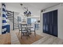 Coastal dining area with round table, spiral staircase and stylish blue accents at 3457 Cyclone Dr, Weeki Wachee, FL 34607