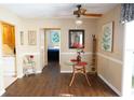 Cozy dining area with hardwood floors, a ceiling fan, and a charming glass table at 408 Gloucester Blvd # 33, Sun City Center, FL 33573