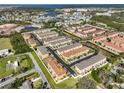 Aerial view of a well-maintained townhome community with multiple buildings, green spaces, and convenient parking at 5036 Sand Castle Dr, New Port Richey, FL 34652