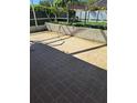 Enclosed brick patio area with a garden wall and view to back yard at 5261 Camberlea Ave, Zephyrhills, FL 33541