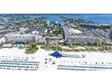 Wide aerial shot of the beach resort with a large water slide on the beach and Gulf waters on a sunny day at 5500 Gulf Blvd # 4226, St Pete Beach, FL 33706