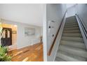View showcasing the entryway with hardwood floors and the carpeted stairs at 5938 Oakhurst Dr, Seminole, FL 33772