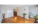 Bright room featuring wood floors, with a glimpse into the dining area at 5938 Oakhurst Dr, Seminole, FL 33772