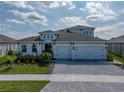 Charming home featuring a paver driveway, well-maintained landscaping, and a two-car garage, enhancing its curb appeal at 6185 Hidden Branch Dr, Apollo Beach, FL 33572