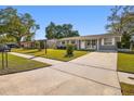 Well-manicured lawn and exterior of a charming one story home in a peaceful neighborhood at 6712 Runningwoods Dr, Tampa, FL 33634