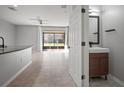 Open-concept living area flows to the screened lanai, adjacent to a modern bathroom at 7047 Towne Lake Rd, Riverview, FL 33578