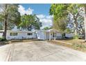 Inviting single-story home with mature trees and a spacious driveway at 766 86Th N Ave, St Petersburg, FL 33702