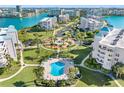 A beautiful condominium community with a sparkling pool, lush landscaping, and stunning waterfront views at 8040 Sailboat Key S Blvd # 402, St Pete Beach, FL 33707