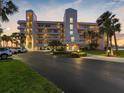 Stunning exterior of condo building featuring manicured landscaping and convenient parking, located near the waterfront at 8040 Sailboat Key S Blvd # 402, St Pete Beach, FL 33707