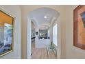 Bright foyer showcasing art niches, wood-look tile flooring and views into the kitchen and living areas at 807 Chipper Dr, Sun City Center, FL 33573