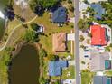 Birds-eye view of residential neighborhood including lake, walking path, and single-Gathering homes at 834 Birdie Way, Apollo Beach, FL 33572