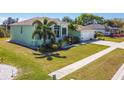 Stylish single-Gathering home boasts a two-car garage, screened porch, lush lawn, and palm trees at 834 Birdie Way, Apollo Beach, FL 33572
